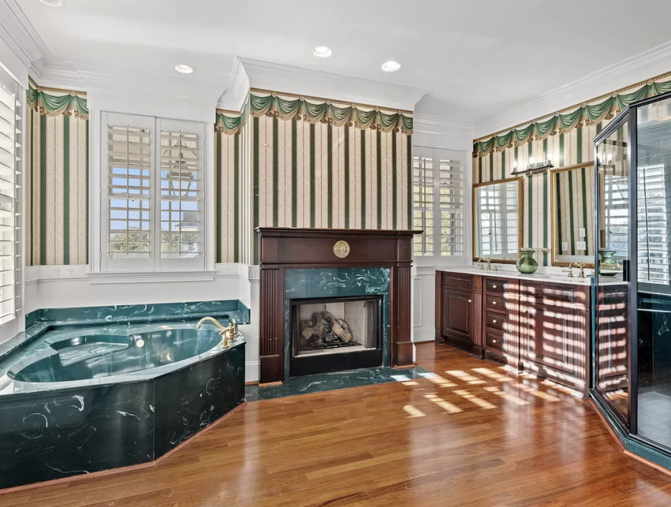 The primary bathroom has a fireplace, tub and separate shower.