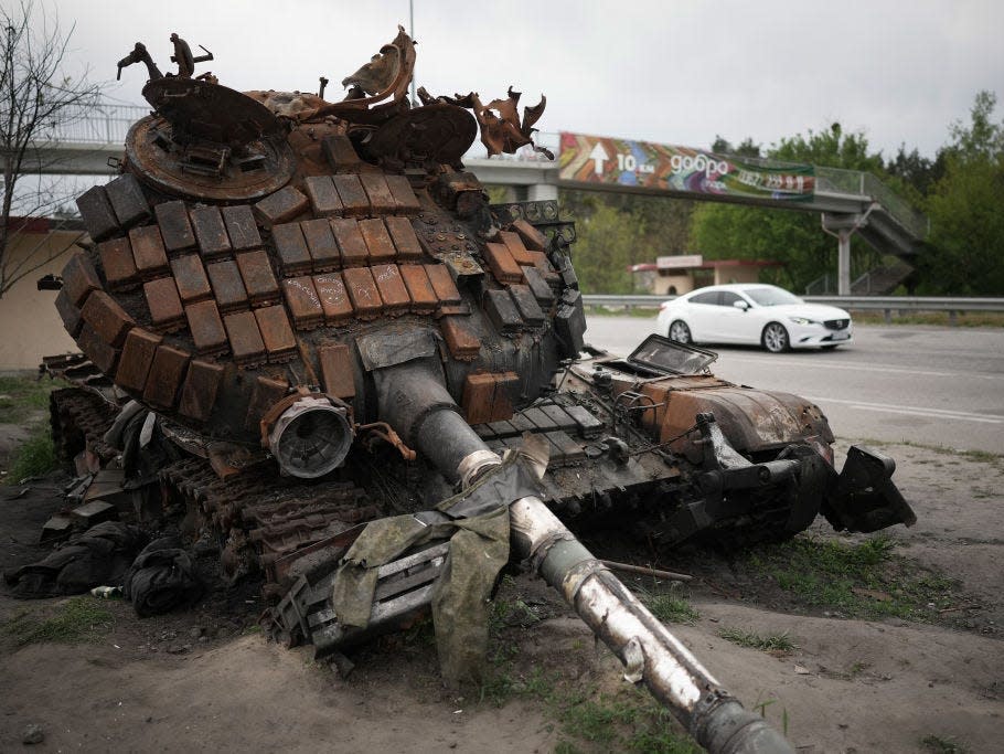 A destroyed Russian main battle tank rusts next to the main highway into the city on May 20, 2022 in Kyiv, Ukraine