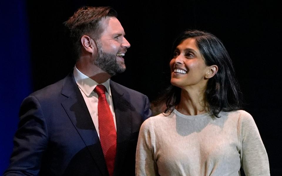 JD Vance, left, and his wife Usha Vance arrive at a campaign rally at Middletown High School