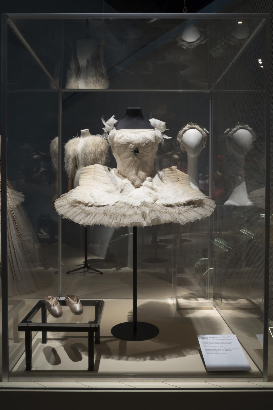 This photo provided by The Museum at FIT shows the “Dying Swan” tutu, head piece, and pointe shoes worn by iconic Russian ballerina Anna Pavlova, that are part of the new exhibit at the Fashion Institute of Technology in New York. The exhibit features 90 items, including ballet costumes, high fashion and athletic wear, or what we call today “athleisure.” (Eileen Costa/The Museum at FIT via AP)