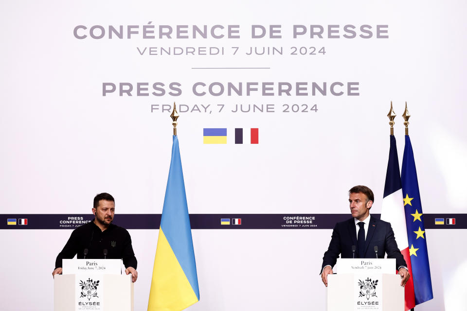 French President Emmanuel Macron, right, reacts during a joint press conference with Ukrainian President Volodymyr Zelenskyy, Friday, June 7, 2024 at the Elysee Palace in Paris. U.S. President Joe Biden was due to meet with Ukrainian President Volodymyr Zelenskyy in Paris on Friday as Kyiv's army endures its hardest days of fighting since the early weeks of the war with Russia and prepares for what officials say could be a tough summer ahead. (Yoan Valat, Pool via AP)