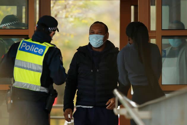 MELBOURNE, AUSTRALIA - JULY 07: People speak with police at the entrance to one of the public housing towers in Kensington on July 07, 2020 in Melbourne, Australia. 