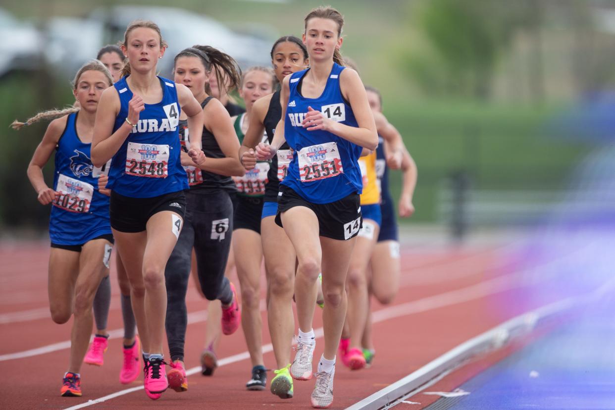 Washburn Rural senior Madeline Carter (4) races Saturday alongside sophomore Rylee Ismert (14) in the girls 1600 meter at the Kansas Relays at Rock Chalk Park in Lawrence.