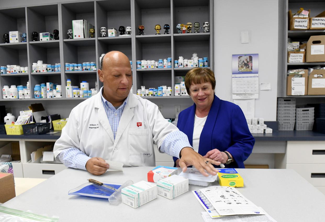 Phamacist William Hubert works with Carol Risaliti, executive director at Beacon Charitable Pharmacy. Cleveland Clinic Mercy Hospital recently donated a former physician's office building on 13th Street NW in Canton to serve as a new home for the pharmacy.