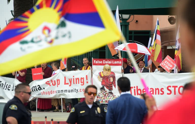 Police stand guard in front of the Honda Center where protesters and supporters of the Dalai Lama gather on July 5, 2015 in Anaheim, California