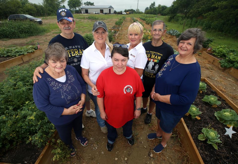 (Front row from left) Connie Strader, Angel Rowley and Billie Strader and (back row) Ron Strader, M.A.S.H. founder Amber Hudson, Sebra Hudson and Don Strader are seen in the M.A.S.H. Pantry Garden on July 27.