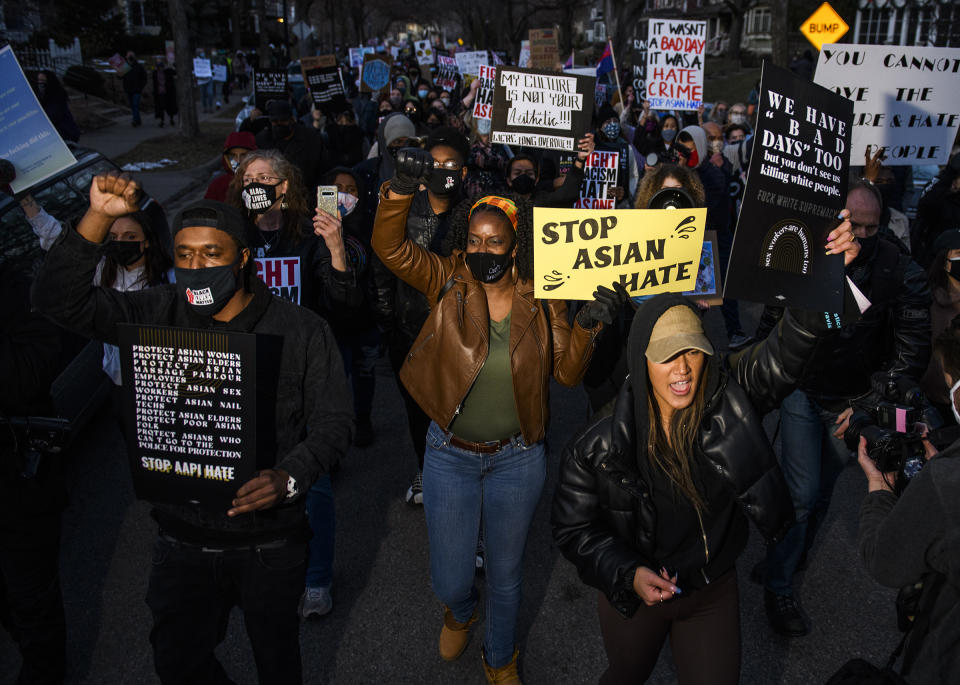 People march through a neighborhood to protest against anti-Asian violence on March 18 in Minneapolis<span class="copyright">Stephen Maturen—Getty Images</span>