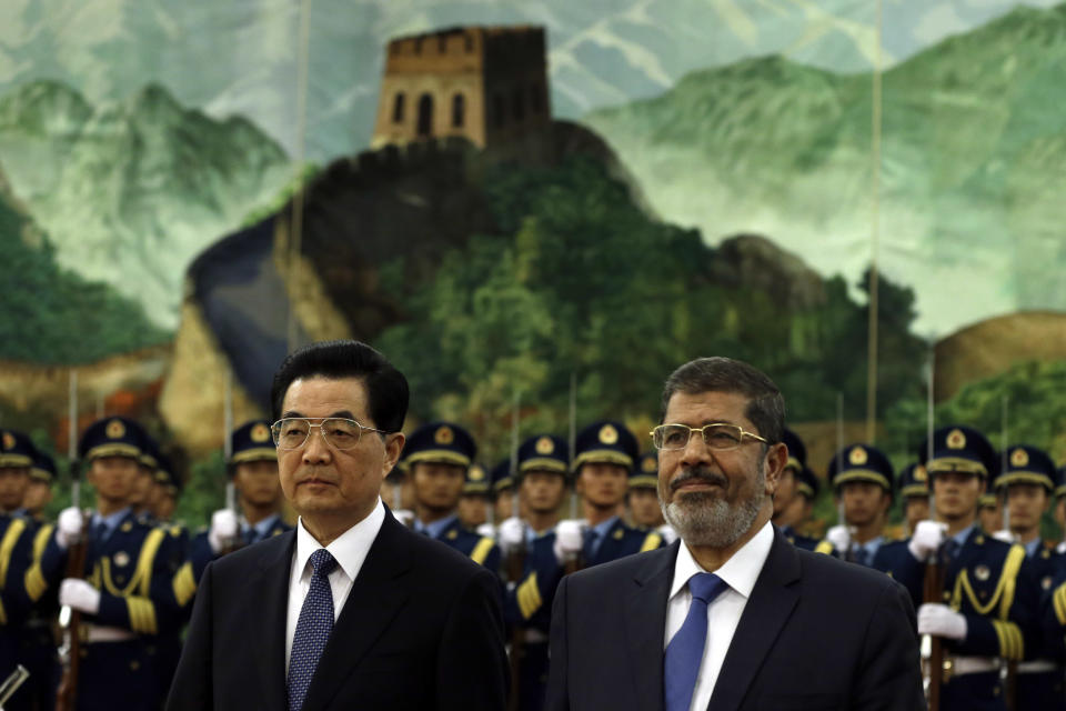 Egyptian President Mohammed Morsi, right, and Chinese President Hu Jintao attend a welcome ceremony at the Great Hall of the People in Beijing, China, Tuesday, Aug. 28, 2012. China is hosting Egypt's newly elected president despite its uneasiness with the Arab Spring revolution that helped bring him to power, while the new leader seeks to shore up his country's flagging economy. (AP Photo/Ng Han Guan)