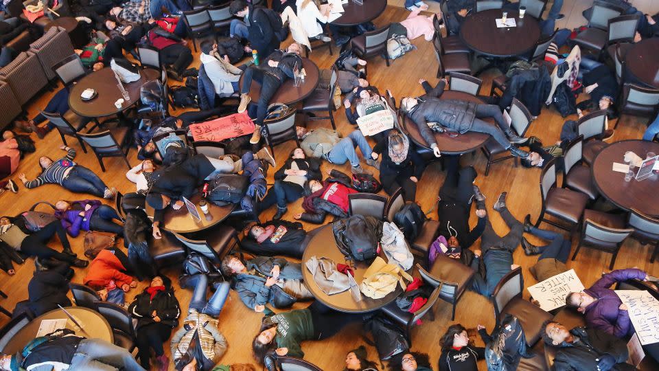 Students stage a "die in" at Washington University to draw attention to police violence against unarmed Black men on December 1, 2014, in St. Louis, Missouri. - Scott Olson/Getty Images