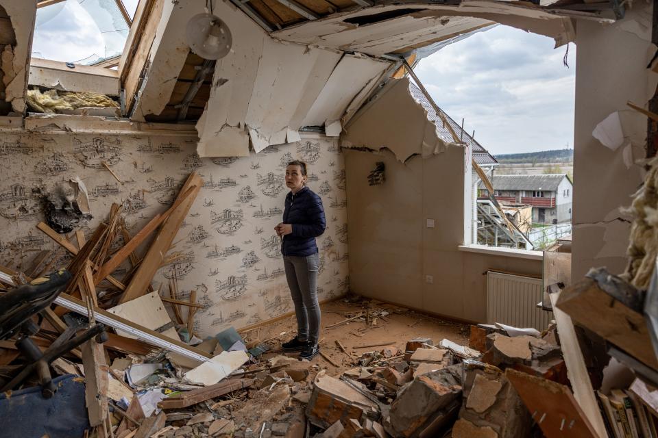 Local resident Oksana surveys the destroyed second floor of her multi-generational home while searching for salvageable items on 25 April 2022 in Hostomel, Ukraine (Getty Images)