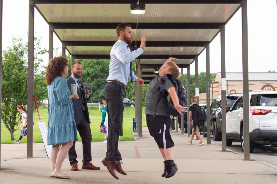 Assistant Principal Nathan Gordon high fives Gage Uphoff, welcoming him into the first day of school at Elzie D. Patton Elementary School in Mt. Juliet , Tenn., Monday, Aug. 1, 2022.