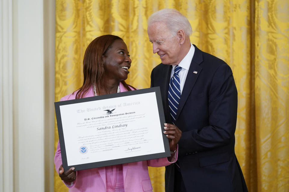 President Joe Biden recognizes Sandra Lindsay as an "Outstanding American by Choice," a U.S. Citizenship and Immigration Services program that recognizes citizens who have been naturalized in the East Room of the White House, Friday, July 2, 2021, in Washington. Lindsay is believed to be the first American to be vaccinated against COVID-19 outside of a clinical trial. She works as director of nursing for critical care at Northwell Health's Long Island Jewish Medical Center in Queens, New York. (AP Photo/Patrick Semansky)