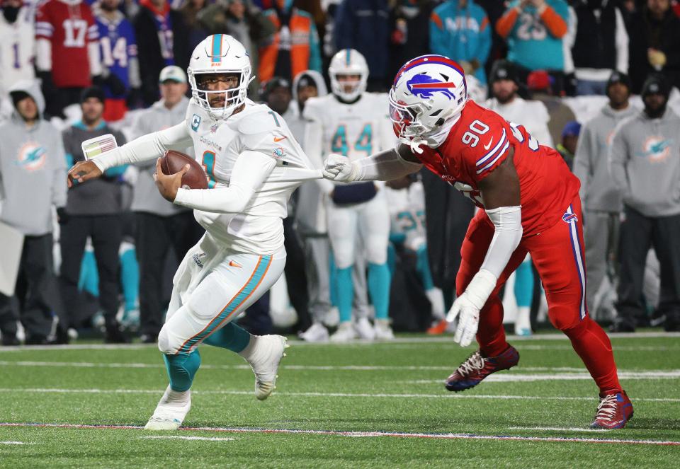 Miami quarterback Tua Tagovailoa is caught from behind by Buffalo’s Shaq Lawson. 