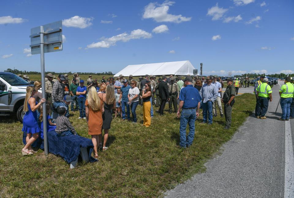 Family, friends and representatives of law enforcement agencies gather along State Road 70 (Okeechobee Road) west of the St. Lucie County Fairgrounds for the Kyle Lee Patterson Memorial Way dedication ceremony on Friday March 29, 2024.