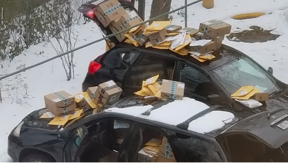 A photo by Don Turton shows Amazon packages piled up on the vehicles in his building’s parking lot. (Don Turton)