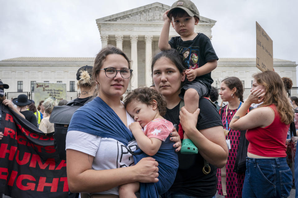 Lauren McKillip, left, holding daughter Thea McKillip, 2, and her wife Marissa McKillip, holding their son Lincoln McKillip, 4, of Crofton, Md., pose for a portrait as they attend an abortion rights rally, Saturday, May 14, 2022, outside the Supreme Court in Washington, during protests across the country. "It's important for us to come here for our daughter, for our marriage," says Marissa McKillip, "for all the things now established so that our daughter doesn't have to fight for it." (AP Photo/Jacquelyn Martin)