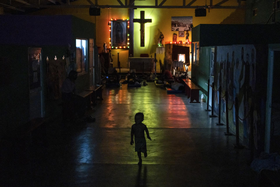 A migrant child runs through an area of the Peace Oasis of the Holy Spirit Amparito shelter where migrants are sleeping on the floor on mats, in Villahermosa, Mexico, June 7, 2024. (AP Photo/Felix Marquez)