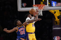 Golden State Warriors forward Jonathan Kuminga (00) and Los Angeles Lakers forward Stanley Johnson (14) go up for a rebound during the first half of an NBA basketball game in Los Angeles, Saturday, March 5, 2022. (AP Photo/Ashley Landis)