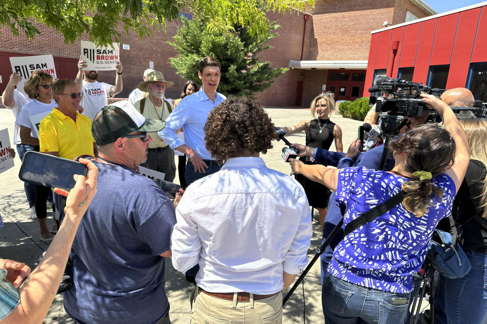 Nevada Senate hopeful Sam Brown speaks to reporters outside Reno High School after casting his primary ballot, Tuesday, June 11, 2024, in Reno, Nev. The retired army captain hopes a late endorsement from former President Donald Trump will help carry him to victory in Nevada's GOP U.S. Senate primary and give him the momentum he needs in the general election to help Republicans flip a seat in the closely divided chamber. (AP Photo/Scott Sonner)