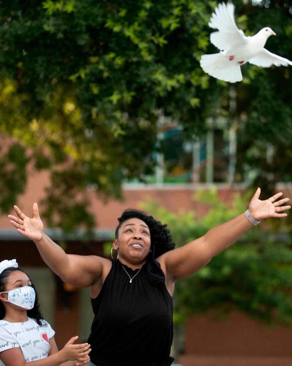 Shannon Utley releases a white dove in honor of Kyron Hinton, one of several families with loved ones who died or faced excessive force at the hands of Raleigh police during a vigil in Moore Square on Tuesday, June 9, 2020 in Raleigh, N.C. Kyron Hinton’s daughter, nine-year-old Kyra Utley stands with her mother.