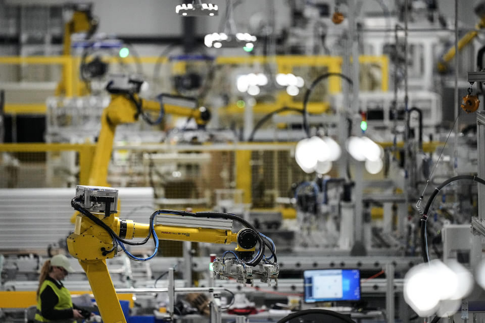 Articulated robots move inside the Hanwha Qcells Solar plant, Monday, Oct. 16, 2023, in Dalton, Ga. The Korean company is opening what it says is the first solar panel factory to begin production in the U.S. since the passage of President Joe Biden’s signature climate legislation. (AP Photo/Mike Stewart)