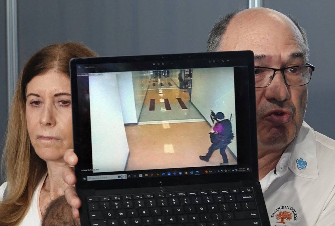 “This was the last thing my son saw,” says Michael Schulman, holding a screen shot of the Parkland shooting as his wife Linda Beigel Schulman looks on after the jury recommended life in prison for Marjory Stoneman Douglas High School shooter Nikolas Cruz at the Broward County Courthouse in Fort Lauderdale on Oct. 13, 2022. Their son, cross-country coach Scott Beigel, was killed in the 2018 shootings.
