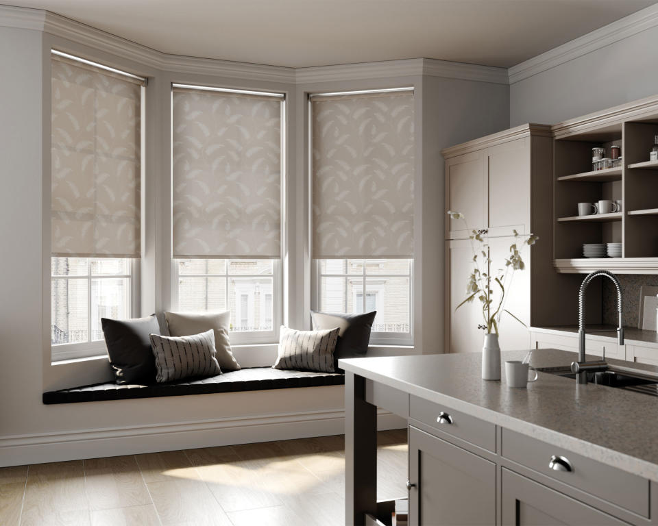 Contemporary gray kitchen with kitchen island, gray blinds on bay window with bench seat