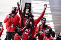 Houston players celebrate after beating Houston 67-61 during an Elite 8 game in the NCAA men's college basketball tournament at Lucas Oil Stadium, Monday, March 29, 2021, in Indianapolis. (AP Photo/Michael Conroy)