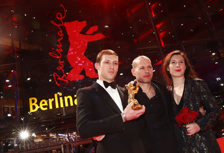 Nadav Lapid , Tom Mercier and Louise Chevillotte pose with Golden Bear for Best Film after the awards ceremony at the 69th Berlinale International Film Festival in Berlin, Germany, February 16, 2019.