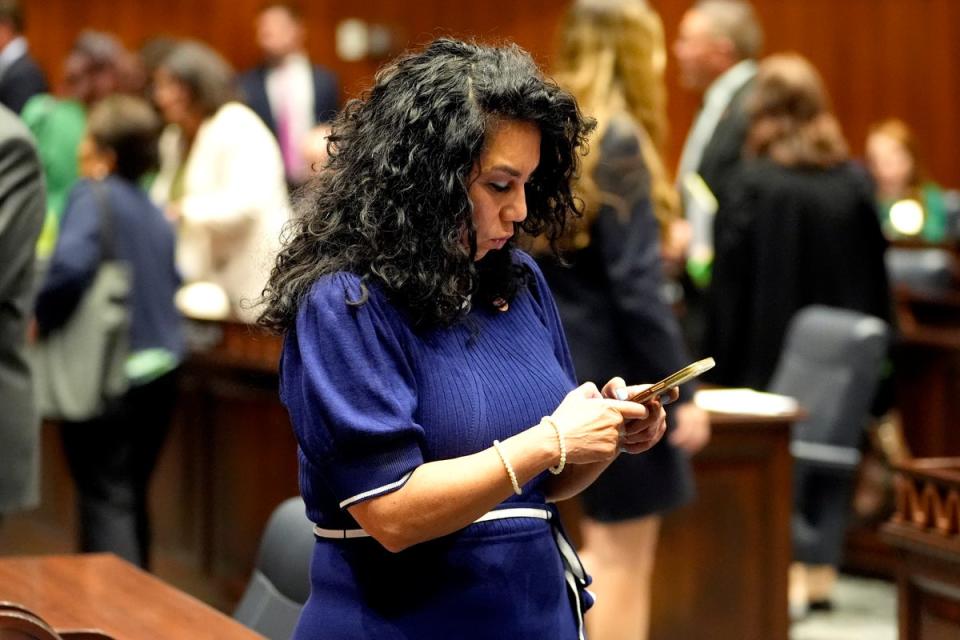 Arizona State Rep Teresa Martinez texts on House floor at the Capitol (AP)