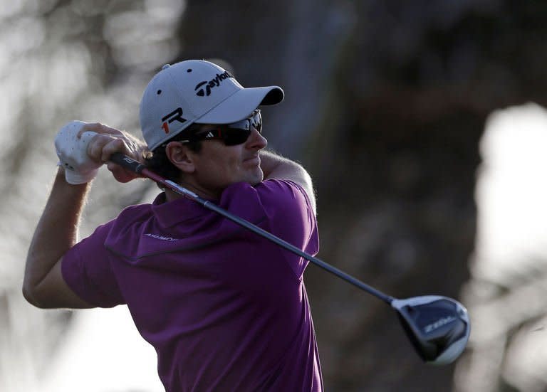 England's Justin Rose plays a shot during the first round of the Abu Dhabi Golf Championship at the Abu Dhabi Golf Club in the Emirati capital on January 17, 2013. Rose grabbed a share of the first round lead in the Abu Dhabi Golf Championship on a day when both Rory McIlroy and Tiger Woods struggled to get their seasons into gear