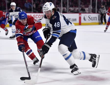 Feb 7, 2019; Montreal, Quebec, CAN; Winnipeg Jets forward Brendan Lemieux (48) skates with the puck as Montreal Canadiens defenseman Mike Reilly (28) defends during the third period at the Bell Centre. Mandatory Credit: Eric Bolte-USA TODAY Sports