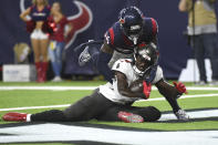 Tampa Bay Buccaneers wide receiver Chris Godwin (14) is tackled by Houston Texans' Desmond King II (25) after making a catch and run for a touchdown during the first half of an NFL preseason football game Saturday, Aug. 28, 2021, in Houston. (AP Photo/Eric Christian Smith)