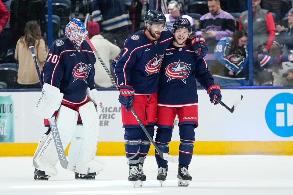 Feb 16, 2023; Columbus, Ohio, USA;  Columbus Blue Jackets center Sean Kuraly (7) hugs defenseman Nick Blankenburg (77) as they skate off the ice following their 3-1 win in the NHL hockey game against the Winnipeg Jets at Nationwide Arena. Mandatory Credit: Adam Cairns-The Columbus Dispatch