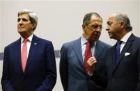 French Foreign Minister Laurent Fabius (R) talks to Russia's Foreign Minister Sergei Lavrov (C) next to U.S. Secretary of State John Kerry during a ceremony at the United Nations in Geneva November 24, 2013. REUTERS/Denis Balibouse