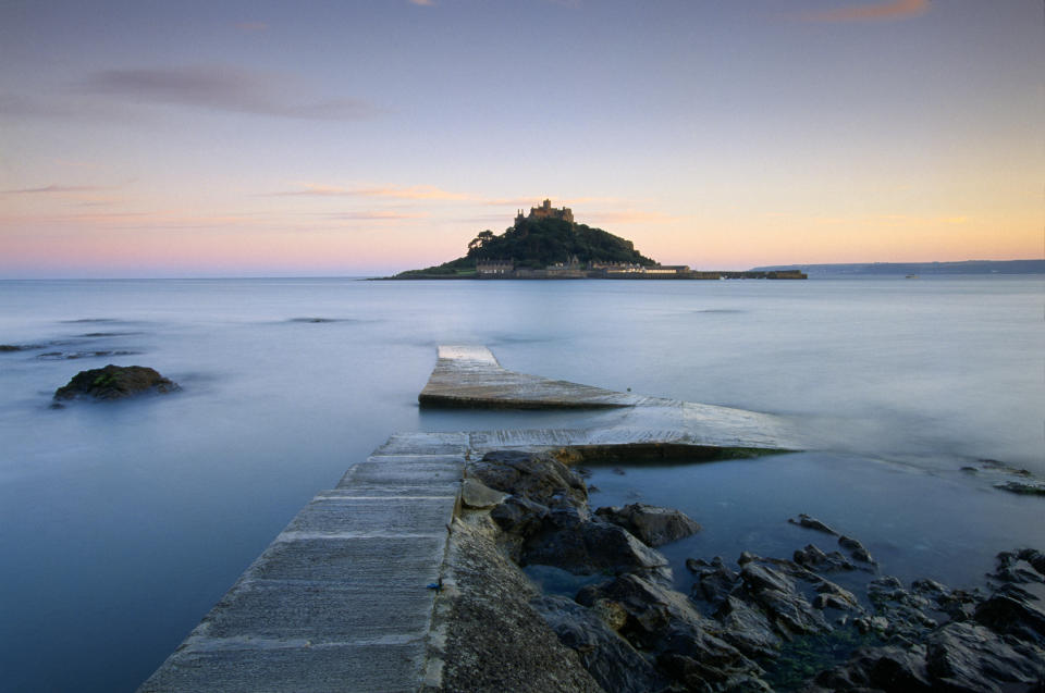 The view of St Michael's Mount silhouetted in a pink dawn. [Photo: National Trust]