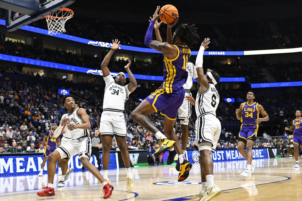 LSU guard Justice Williams (11) shoots as Vanderbilt forward Lee Dort (34) and guard Ezra Manjon (5) defend during the first half of an NCAA college basketball game in the second round of the Southeastern Conference tournament, Thursday, March 9, 2023, in Nashville, Tenn. (AP Photo/John Amis)