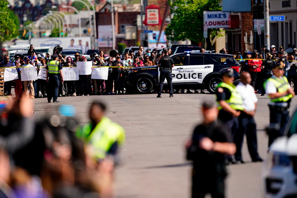 Members of the public are held off at a distance as President Biden and First Lady Jill Biden visit the scene of a Buffalo shooting at a supermarket to pay respects to victims, May 17, 2022. (AP Photo/Matt Rourke)