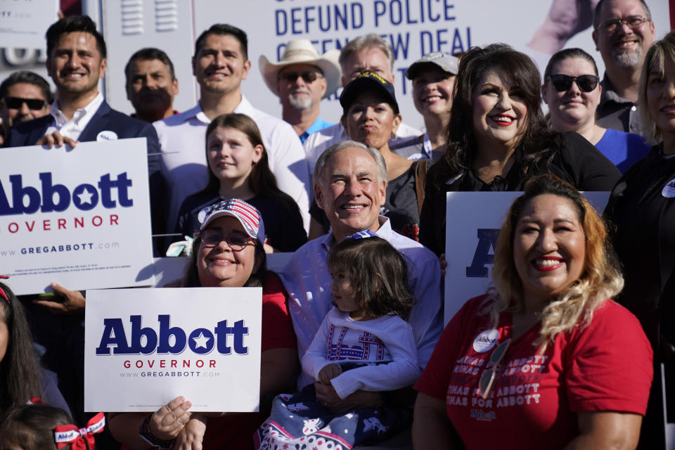 Texas Gov. Greg Abbott, center, poses with supporters as prepares to canvass for votes, Saturday, Oct. 1, 2022, in Harlingen, Texas. As Democrats embark on another October blitz in pursuit of flipping America's biggest red state, Republicans are taking a swing of their own: Making a play for the mostly Hispanic southern border on Nov. 8 after years of writing off the region that is overwhelmingly controlled by Democrats. (AP Photo/Eric Gay)