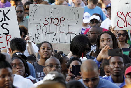 Protestors listen during a rally against what demonstrators call police brutality in McKinney, Texas June 8, 2015. REUTERS/Mike Stone