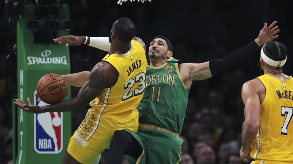 Boston Celtics center Enes Kanter (11) blocks the ball as he stops a drive to the basket by Los Angeles Lakers forward LeBron James (23) during the first half of an NBA basketball game in Boston, Monday, Jan. 20, 2020. The Celtics defeated the Lakers 139-107. (AP Photo/Charles Krupa)