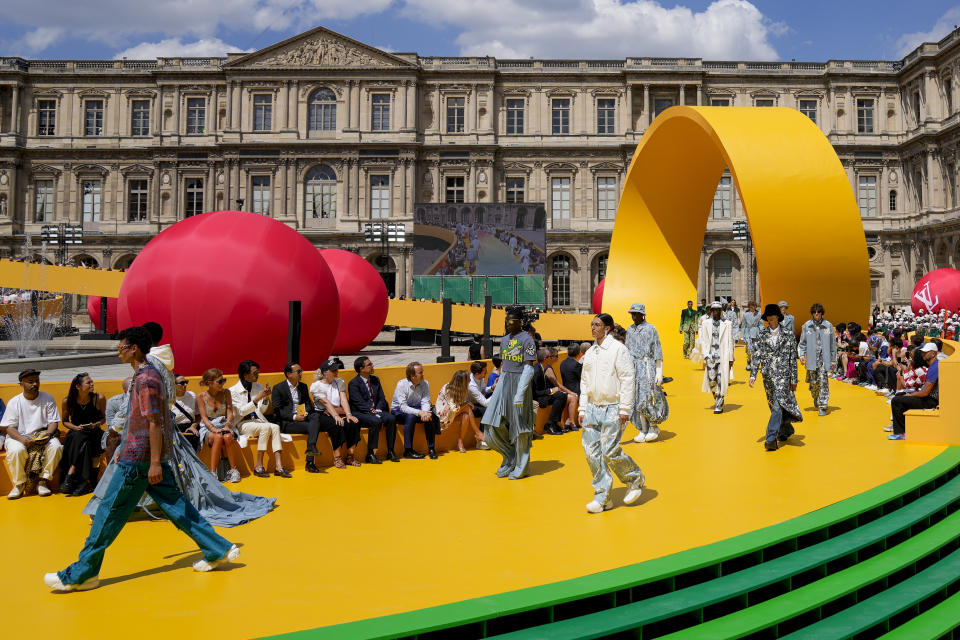 CORRECTS DATE Models wear creations as part of the Louis Vuitton men's Spring Summer 2023 collection presented in Paris, France, Thursday, June 23, 2022. (AP Photo/Francois Mori)