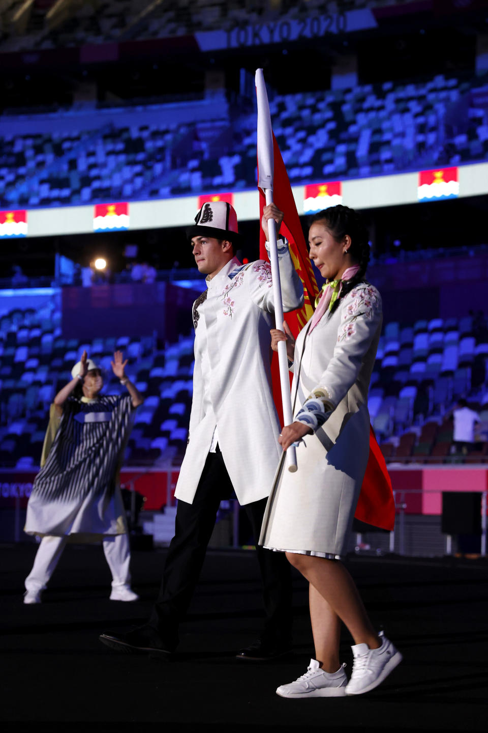 TOKYO, JAPAN - JULY 23: Flag bearers Kanykei Kubanychbekova and Denis Petrashov of Team Kyrgyzstan during the Opening Ceremony of the Tokyo 2020 Olympic Games at Olympic Stadium on July 23, 2021 in Tokyo, Japan. (Photo by Jamie Squire/Getty Images)