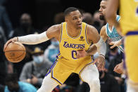 Los Angeles Lakers guard Russell Westbrook (0) is guarded by Charlotte Hornets forward Cody Martin (11) during the first half of an NBA basketball game in Charlotte, N.C., Friday, Jan. 28, 2022. (AP Photo/Jacob Kupferman)