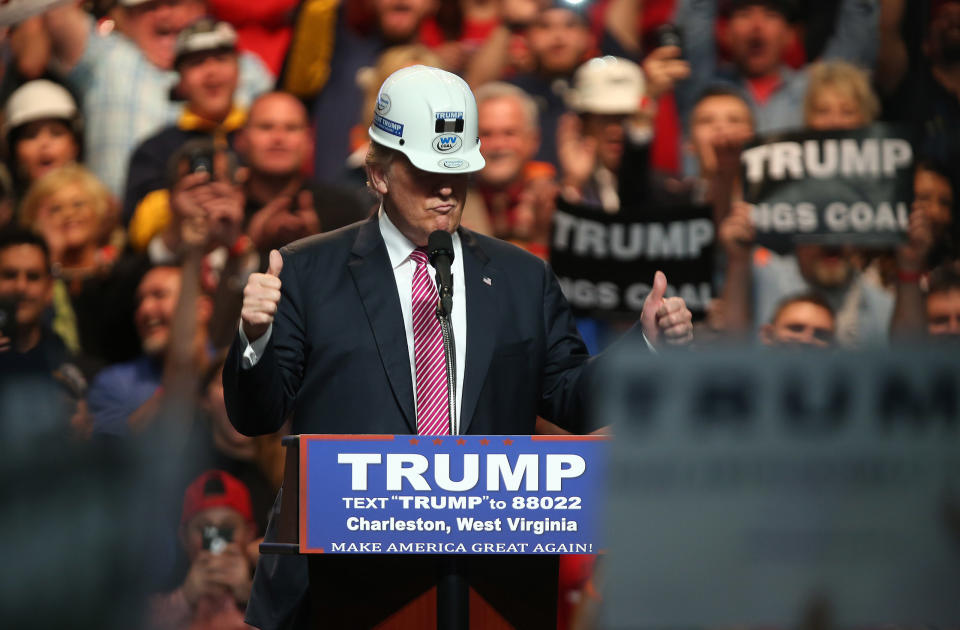 Republican Presidential candidate Donald Trump models a hard hat in support of the miners during his rally at the Charleston Civic Center on May 5, 2016 in Charleston, West Virginia. | Mark Lyons—Getty Images