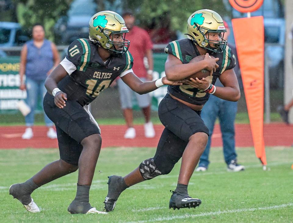 Trinity Catholic's Preston Wright (10) hands off to Antwon Blanchard (22) during a game between Trinity Catholic High School and Tampa Carrollwood Day High School in Ocala on Friday, Sept. 15, 2023. [PAUL RYAN / CORRESPONDENT]
