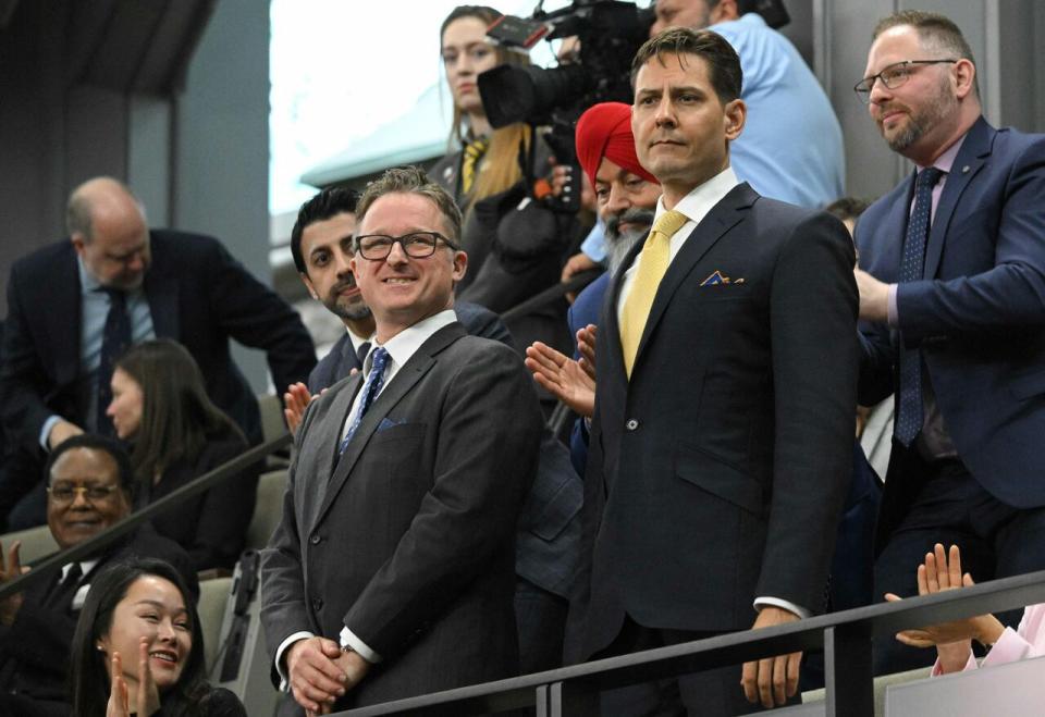 Canadians Michael Kovrig and Michael Spavor stand as they are recognized before an address from US President Joe Biden in the Canadian House of Commons on Parliament Hill in Ottawa, Canada, on March 24, 2023.