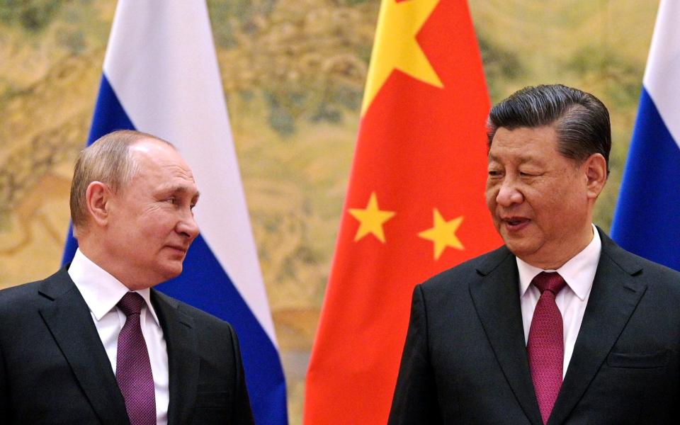 FILE - Chinese President Xi Jinping, right, and Russian President Vladimir Putin talk to each other during their meeting in Beijing, China on Feb. 4, 2022. China says President Xi will visit Russia from Monday, March 20, to Wednesday, March 22, 2023, in an apparent show of support for Russian President Putin amid sharpening east-west tensions over the conflict in Ukraine. (Alexei Druzhinin, Sputnik, Kremlin Pool Photo via AP, File) - Alexei Druzhinin, Sputnik, Kremlin Pool Photo via AP,