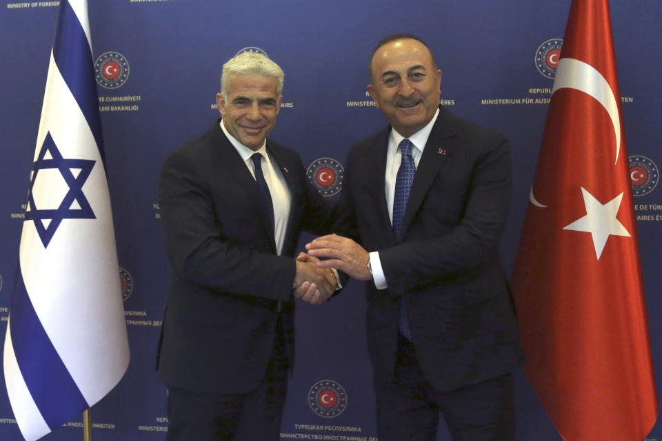 Turkish Foreign Minister Mevlut Cavusoglu, right, and Israeli Foreign Minister Yair Lapid pose for photos before their talks, in Ankara, Turkey, Thursday, June 23, 2022. Turkish authorities have detained five Iranian suspected of planning attacks against Israelis, Turkish media reports said Thursday, ahead of a visit to Turkey by Lapid. Lapid met Cavusoglu on Thursday as the two countries press ahead with efforts to repair ties that have been strained over Turkey's strong support for the Palestinians. (Necati Savas, Pool Photo via AP)