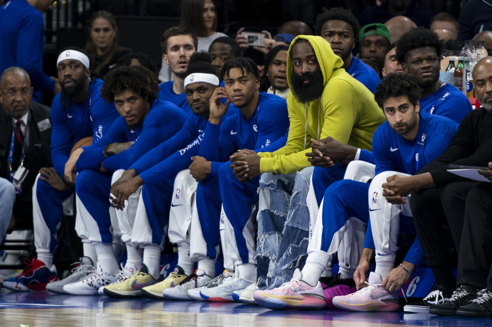Philadelphia 76ers' James Harden, third from right, looks on from the bench with his teammates during the first half of an NBA basketball game against the Portland Trail Blazers, Sunday, Oct. 29, 2023, in Philadelphia. (AP Photo/Chris Szagola)
